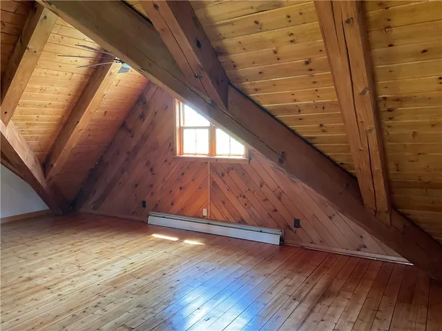 a view of a livingroom with wooden floor and stairs