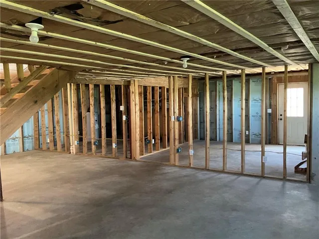 a view of an empty room with a birdcage and a window