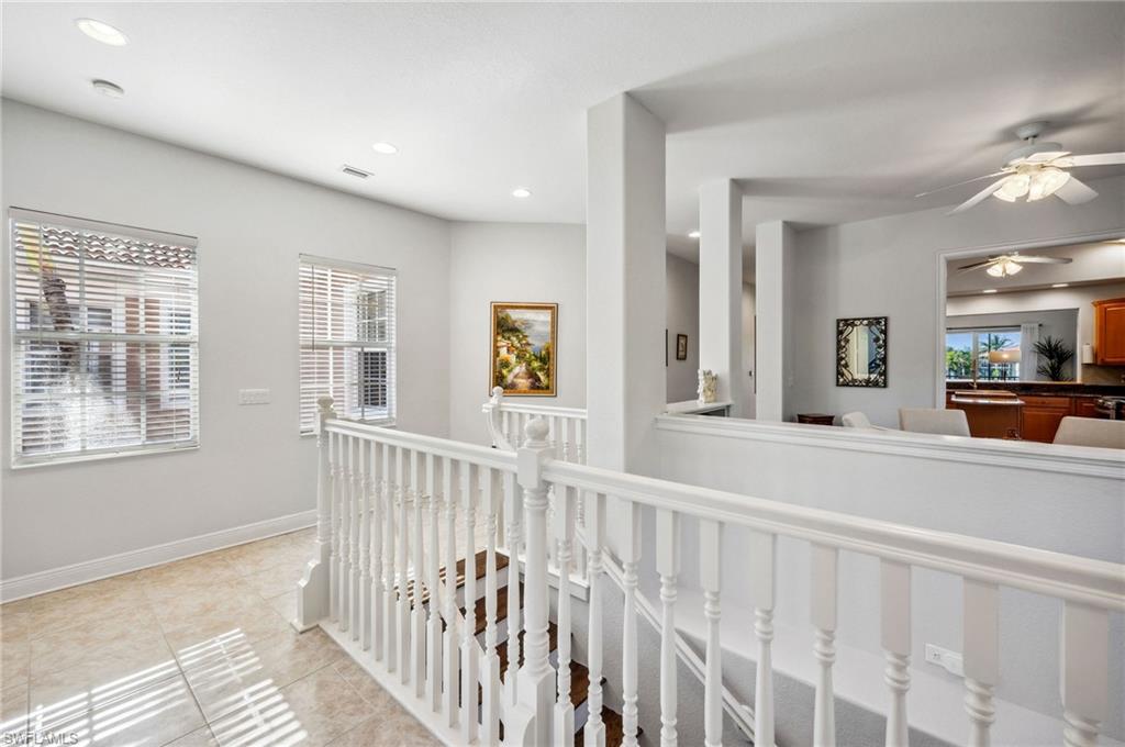 7859 Hawthorne Terrace, Unit 1504 Naples, FL 34113 - Photo 16 of 43 a view of a bedroom with wooden floor and windows