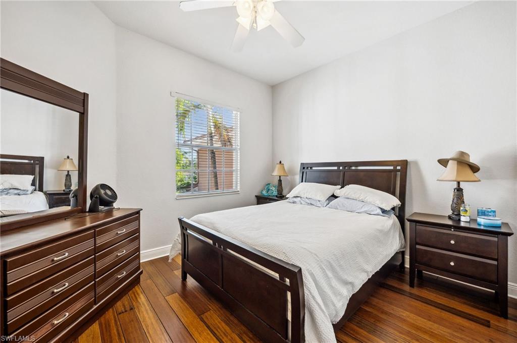 7859 Hawthorne Terrace, Unit 1504 Naples, FL 34113 - Photo 20 of 43 a bedroom with a bed and a dresser