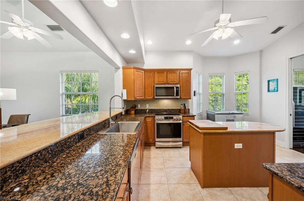 7859 Hawthorne Terrace, Unit 1504 Naples, FL 34113 - Photo 2 of 43 a kitchen with stainless steel appliances granite countertop a sink stove and refrigerator