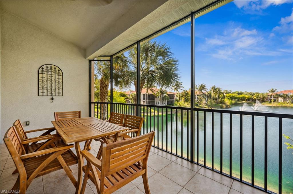 7859 Hawthorne Terrace, Unit 1504 Naples, FL 34113 - Photo 2 of 43 a view of a balcony with chairs and wooden fence