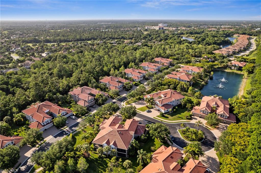 7859 Hawthorne Terrace, Unit 1504 Naples, FL 34113 - Photo 30 of 43 an aerial view of residential houses with outdoor space and trees