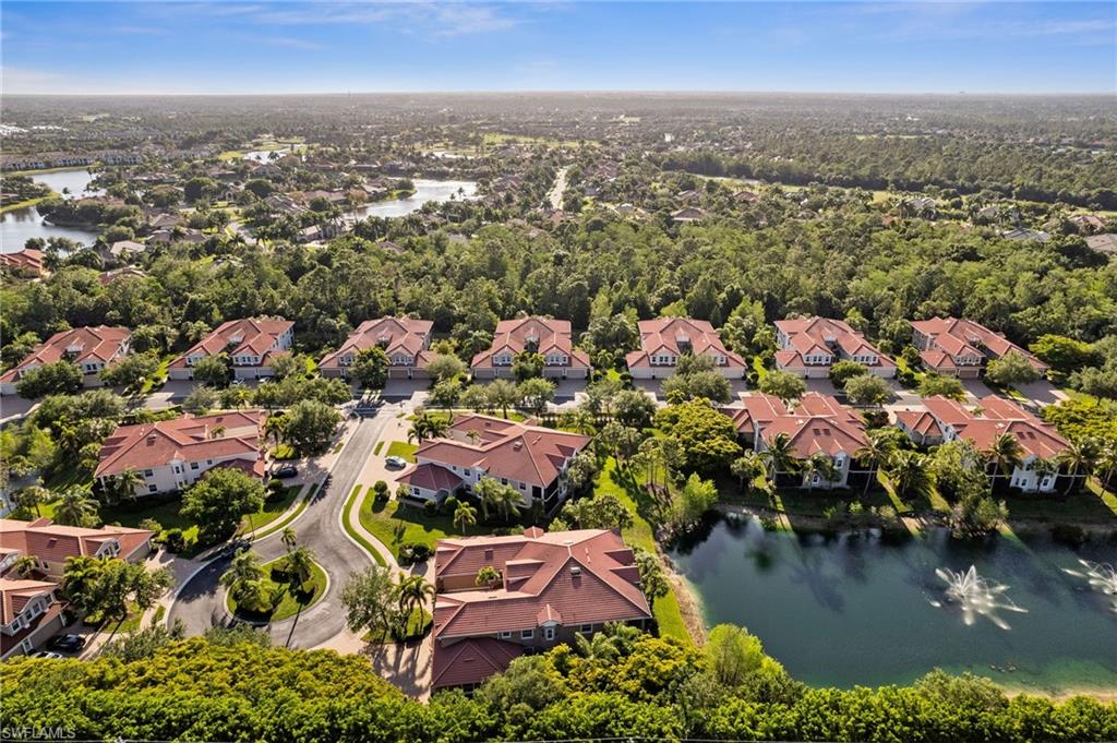 7859 Hawthorne Terrace, Unit 1504 Naples, FL 34113 - Photo 36 of 43 an aerial view of residential houses with outdoor space and trees
