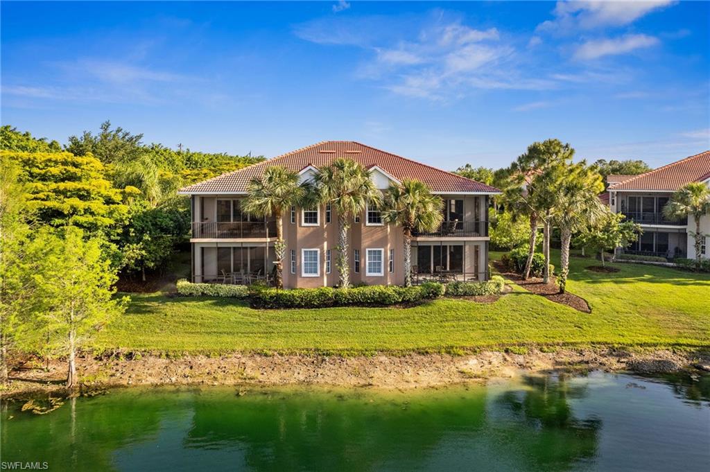 7859 Hawthorne Terrace, Unit 1504 Naples, FL 34113 - Photo 5 of 43 a front view of a house with a garden