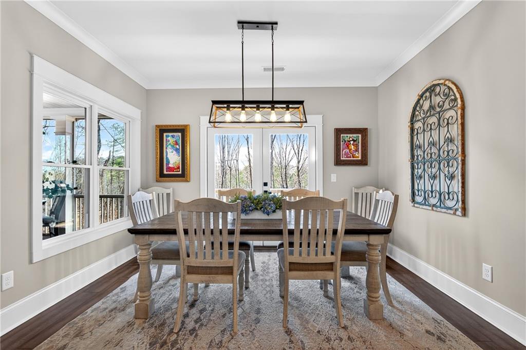 353 Newt Green Road Ball Ground, GA 30107 - Photo 13 of 52 a view of a dining room with furniture window and wooden floor