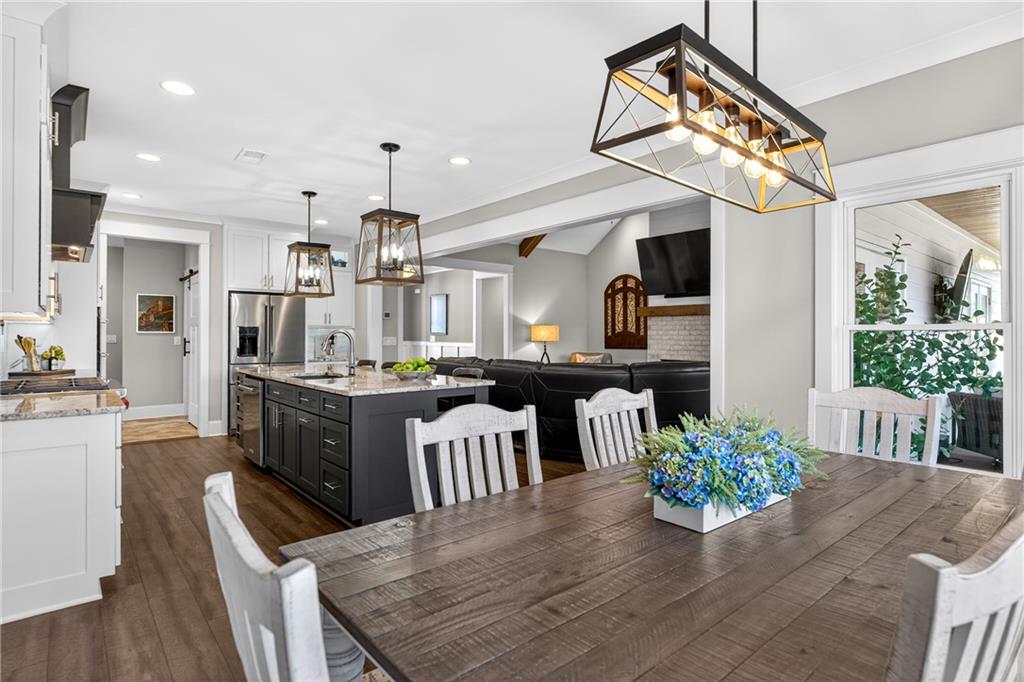 353 Newt Green Road Ball Ground, GA 30107 - Photo 14 of 52 a kitchen with a table and chairs