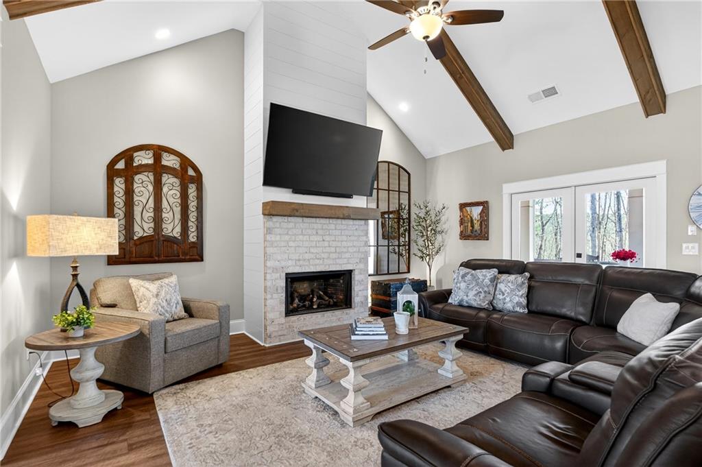 353 Newt Green Road Ball Ground, GA 30107 - Photo 15 of 52 a living room with furniture fireplace and a flat screen tv