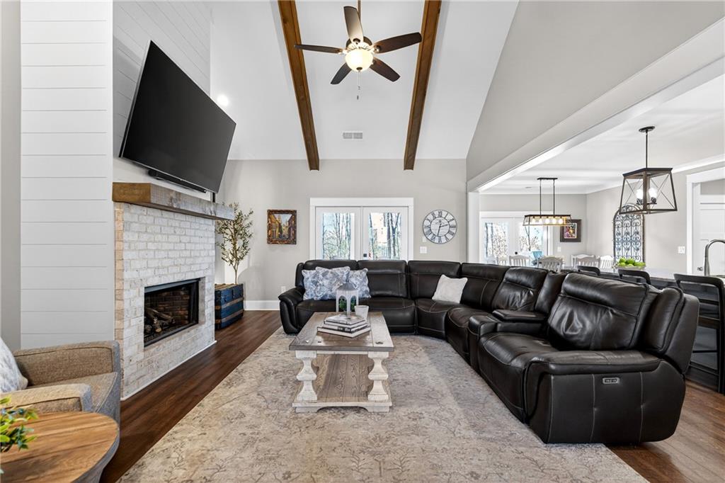 353 Newt Green Road Ball Ground, GA 30107 - Photo 16 of 52 a living room with furniture a fireplace and a flat screen tv