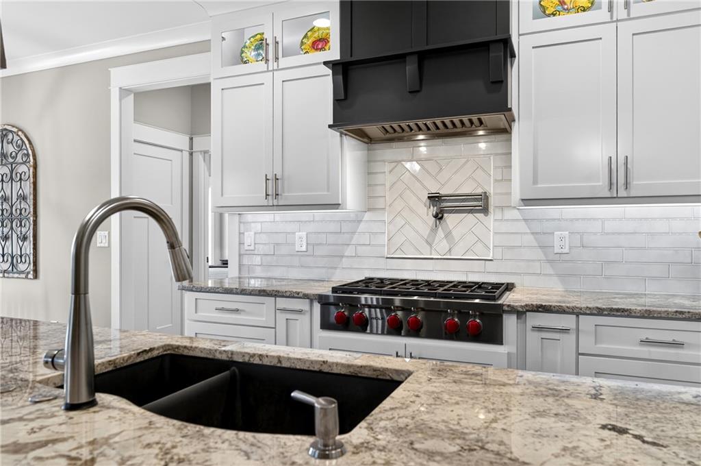 353 Newt Green Road Ball Ground, GA 30107 - Photo 22 of 52 a kitchen with stainless steel appliances kitchen island a stove a sink and a microwave