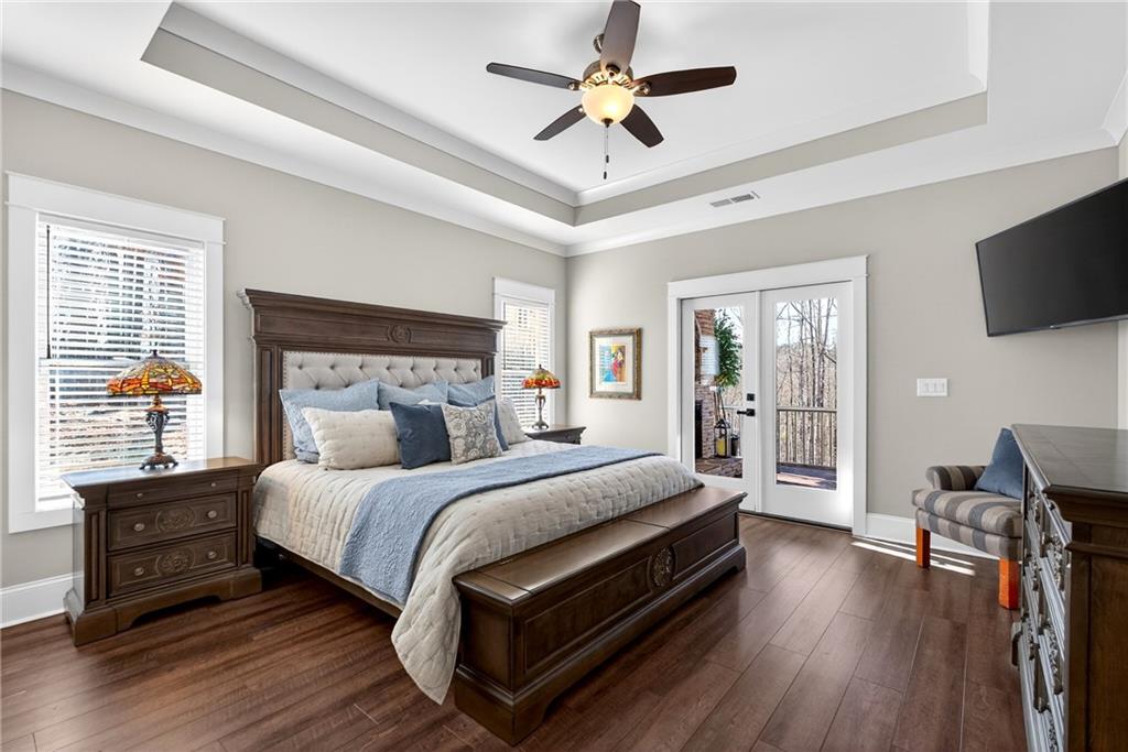 353 Newt Green Road Ball Ground, GA 30107 - Photo 24 of 52 a bedroom with a bed and a flat tv screen on dresser