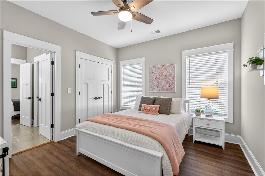 353 Newt Green Road Ball Ground, GA 30107 - Photo 28 of 52 a bedroom with a bed and wooden floor