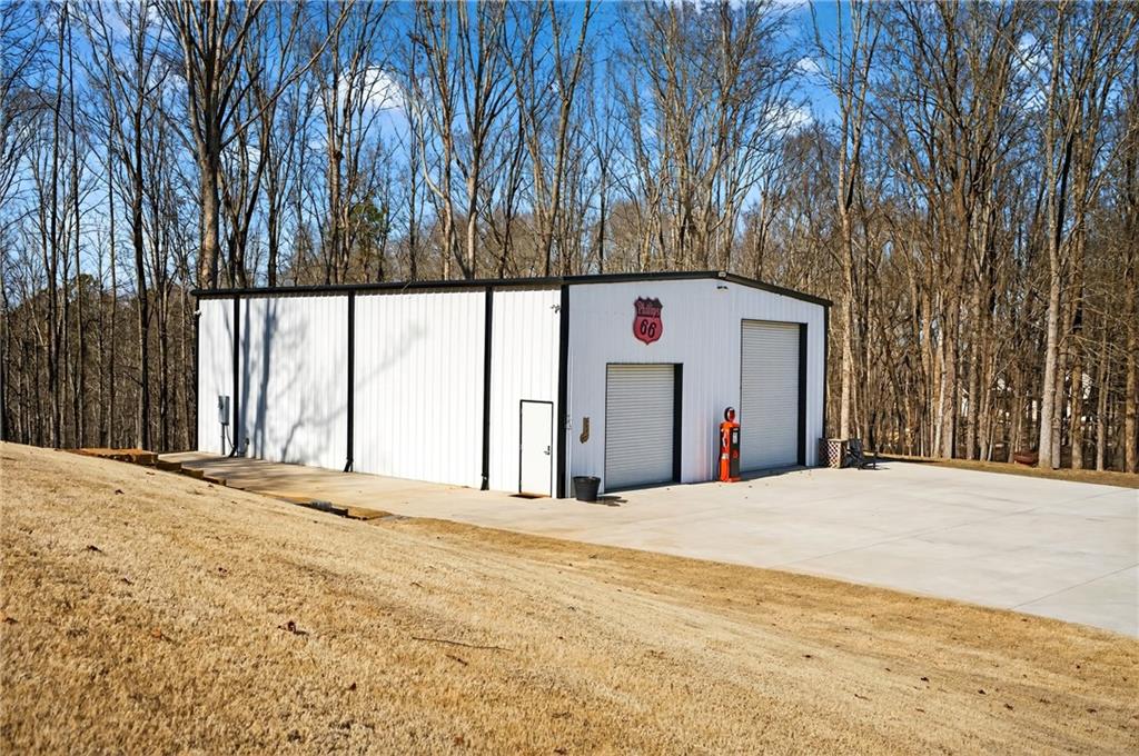 353 Newt Green Road Ball Ground, GA 30107 - Photo 3 of 52 a view of white house with a snow on the road