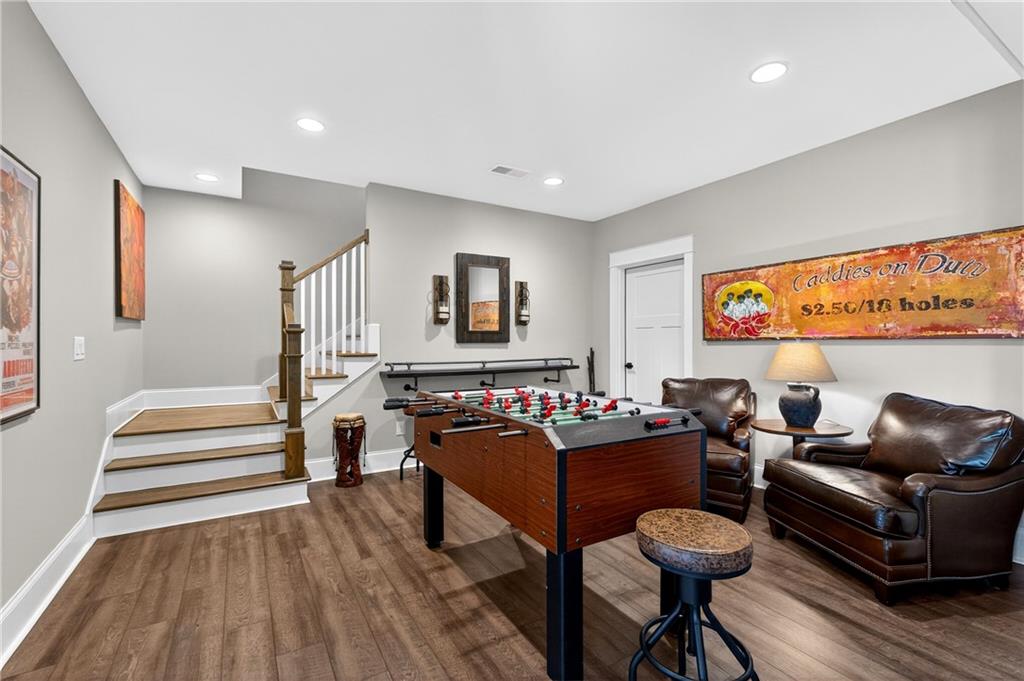 353 Newt Green Road Ball Ground, GA 30107 - Photo 37 of 52 a living room with furniture and a wooden floor