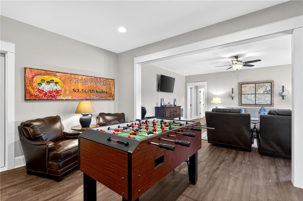 353 Newt Green Road Ball Ground, GA 30107 - Photo 38 of 52 a living room with furniture and a flat screen tv