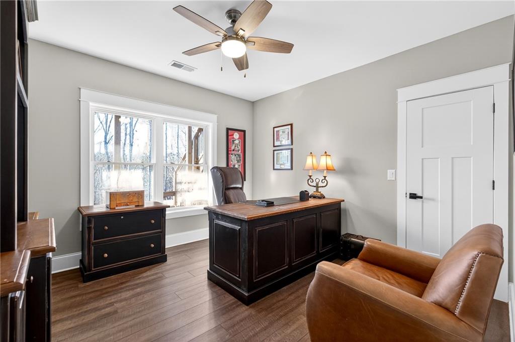353 Newt Green Road Ball Ground, GA 30107 - Photo 39 of 52 a living room with furniture a flat screen tv and a window