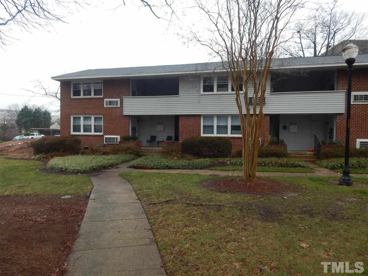 623 Daniels Street, Unit D Raleigh, NC 27605 - Photo 1 of 6 a front view of a house with a yard and garage