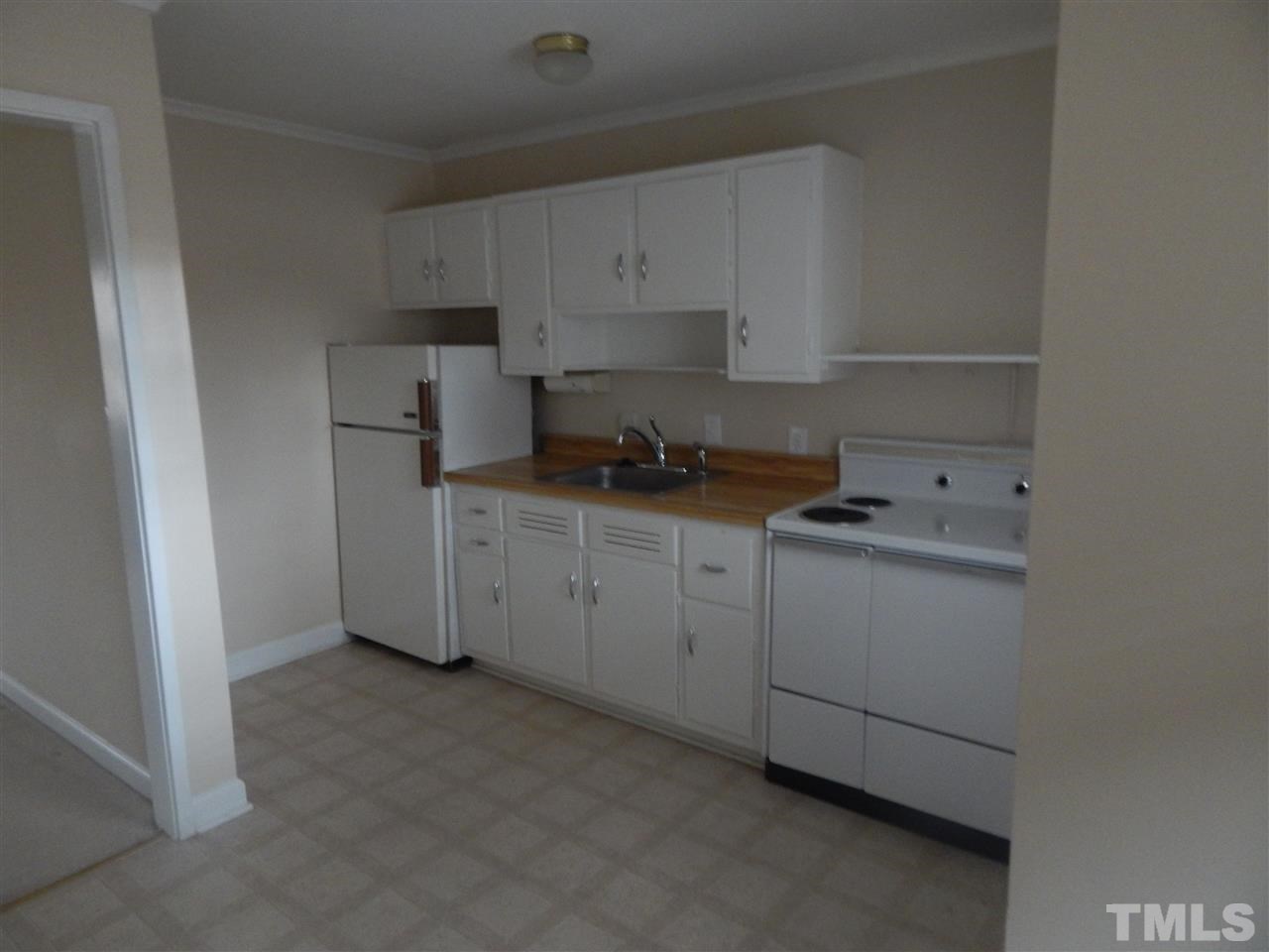 623 Daniels Street, Unit D Raleigh, NC 27605 - Photo 2 of 6 a kitchen with cabinets appliances a sink and a counter top