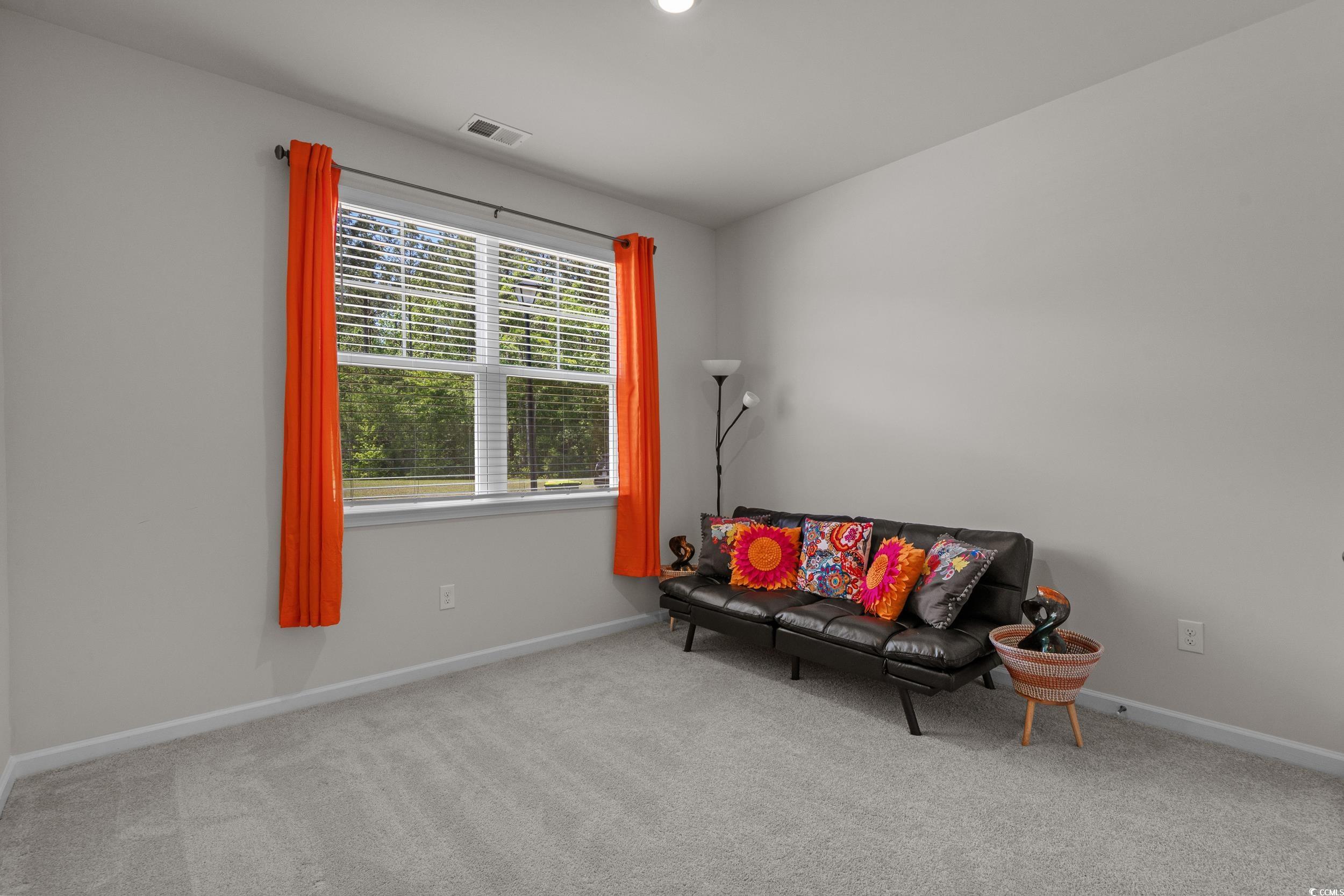 847 Flowering Br Avenue Little River, SC 29566 - Photo 11 of 30 Living area featuring carpet floors and baseboards