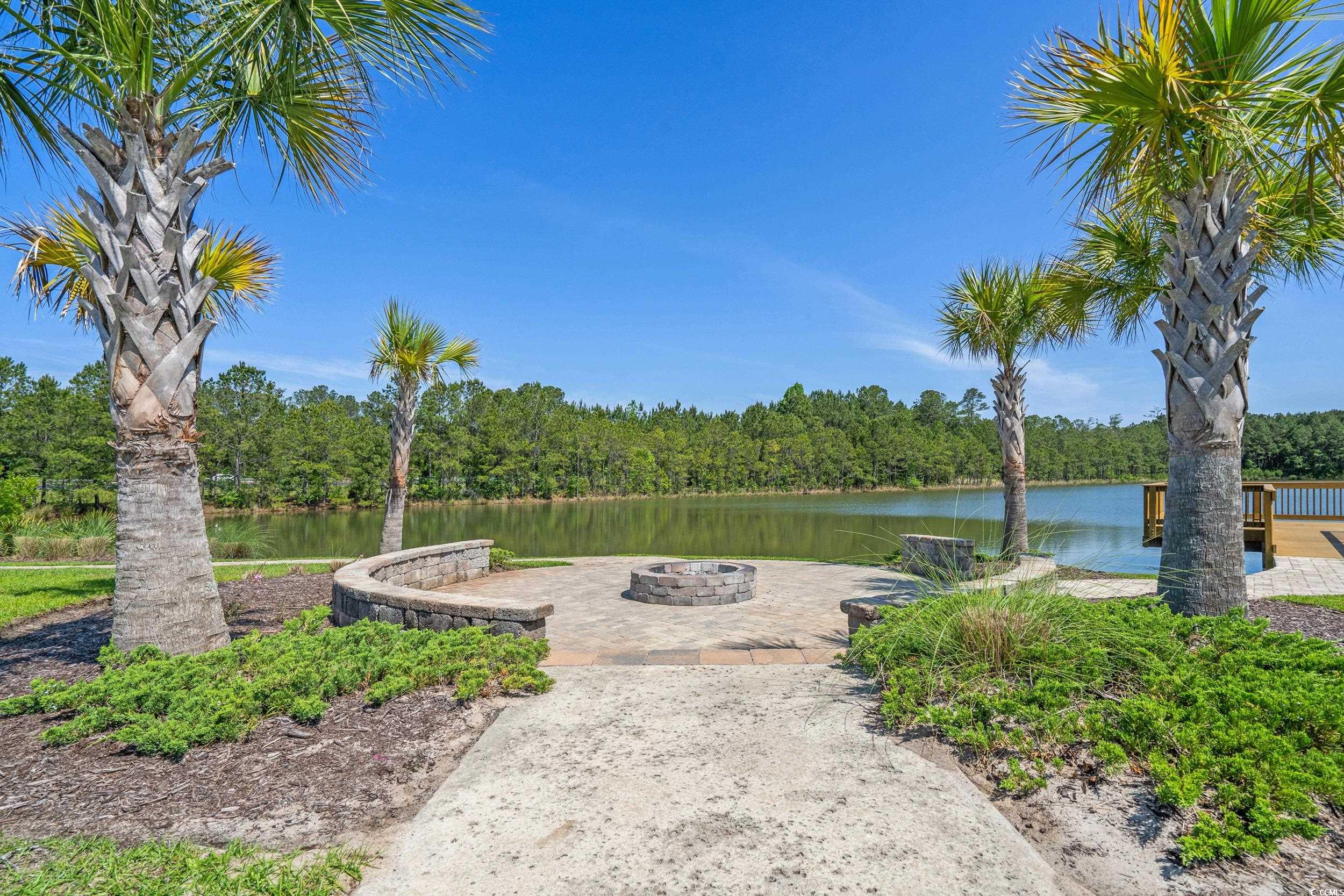 847 Flowering Br Avenue Little River, SC 29566 - Photo 23 of 30 View of yard featuring a water view, an outdoor fire pit, and a patio