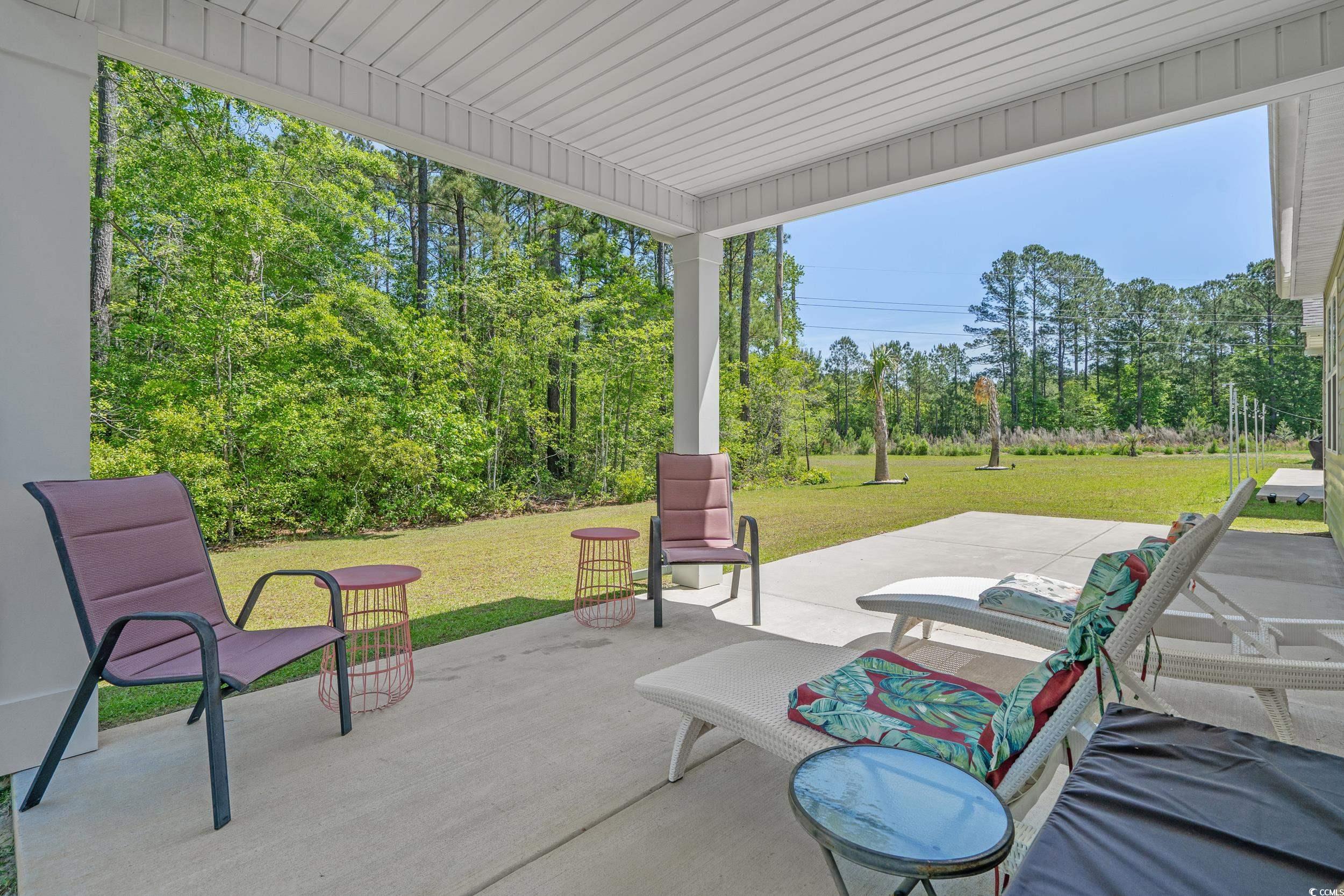 847 Flowering Br Avenue Little River, SC 29566 - Photo 26 of 30 View of patio with view of wooded area