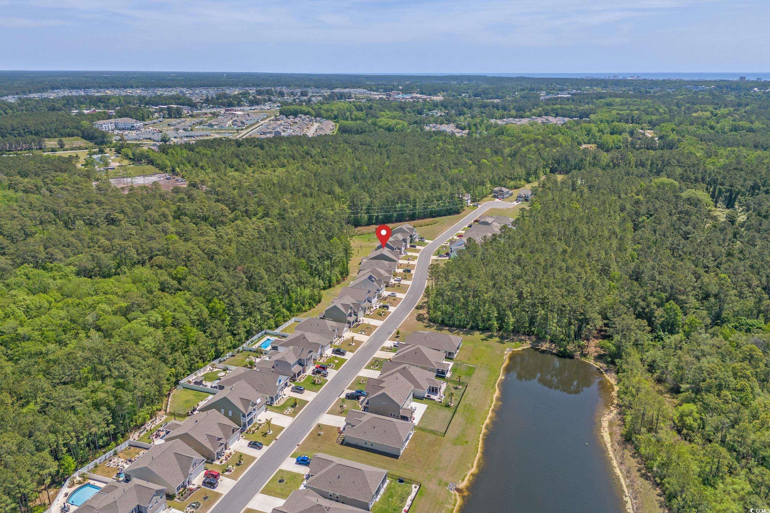847 Flowering Br Avenue Little River, SC 29566 - Photo 27 of 30 Aerial overview of property's location featuring a large body of water and nearby suburban area