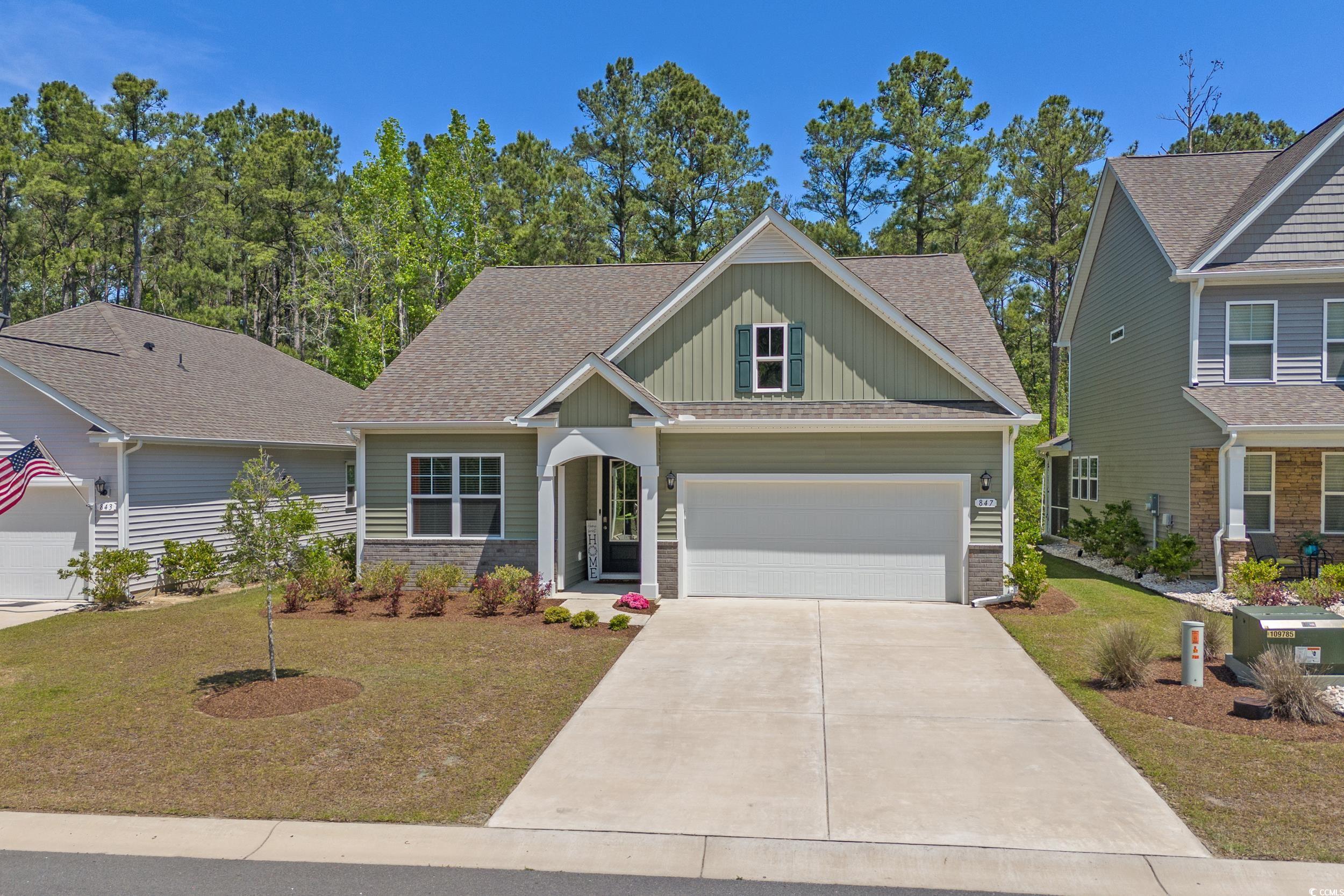 847 Flowering Br Avenue Little River, SC 29566 - Photo 28 of 30 Craftsman-style house with board and batten siding, a shingled roof, a front yard, and driveway