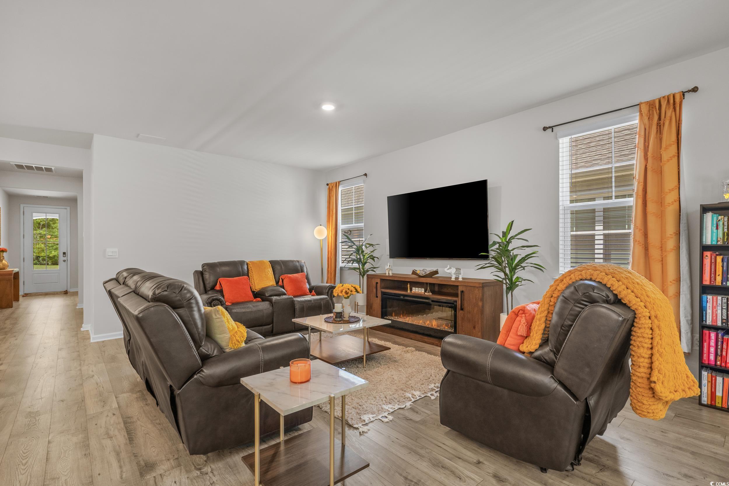 847 Flowering Br Avenue Little River, SC 29566 - Photo 4 of 30 Living room featuring light wood-style floors, recessed lighting, and a glass covered fireplace