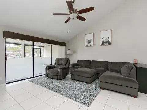 a bedroom with bed and a large window