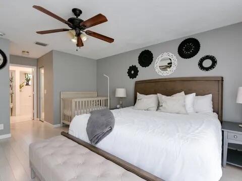 20851 Boca Ridge Drive North Boca Raton, FL 33428 - Photo 21 of 36 a bedroom with a large bed and a large window