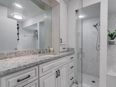 20851 Boca Ridge Drive North Boca Raton, FL 33428 - Photo 22 of 36 a bathroom with a granite countertop sink two mirror and shower
