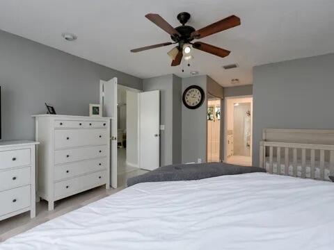 20851 Boca Ridge Drive North Boca Raton, FL 33428 - Photo 23 of 36 a view of a livingroom with a dresser a ceiling fan and wooden floor