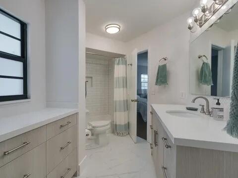 20851 Boca Ridge Drive North Boca Raton, FL 33428 - Photo 29 of 36 a bathroom with a sink a toilet and shower