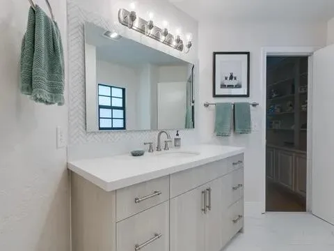 a bedroom with two beds and a chandelier