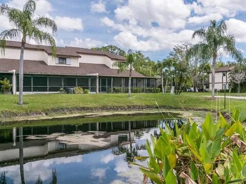 20851 Boca Ridge Drive North Boca Raton, FL 33428 - Photo 3 of 36 a front view of a house with a garden