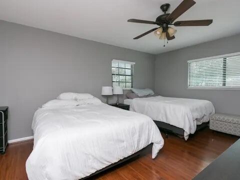 20851 Boca Ridge Drive North Boca Raton, FL 33428 - Photo 31 of 36 a spacious bedroom with two beds and a chandelier
