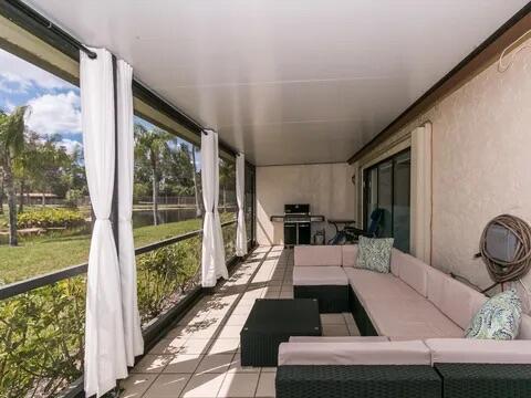 20851 Boca Ridge Drive North Boca Raton, FL 33428 - Photo 34 of 36 a living room with furniture and a floor to ceiling window