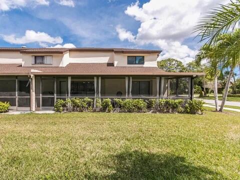 20851 Boca Ridge Drive North Boca Raton, FL 33428 - Photo 5 of 36 a front view of a house with a yard