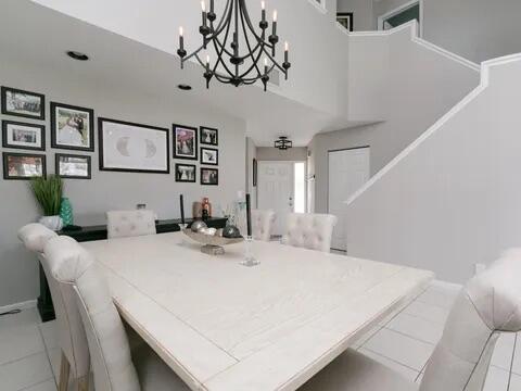 20851 Boca Ridge Drive North Boca Raton, FL 33428 - Photo 9 of 36 a bedroom with a bed and a chandelier