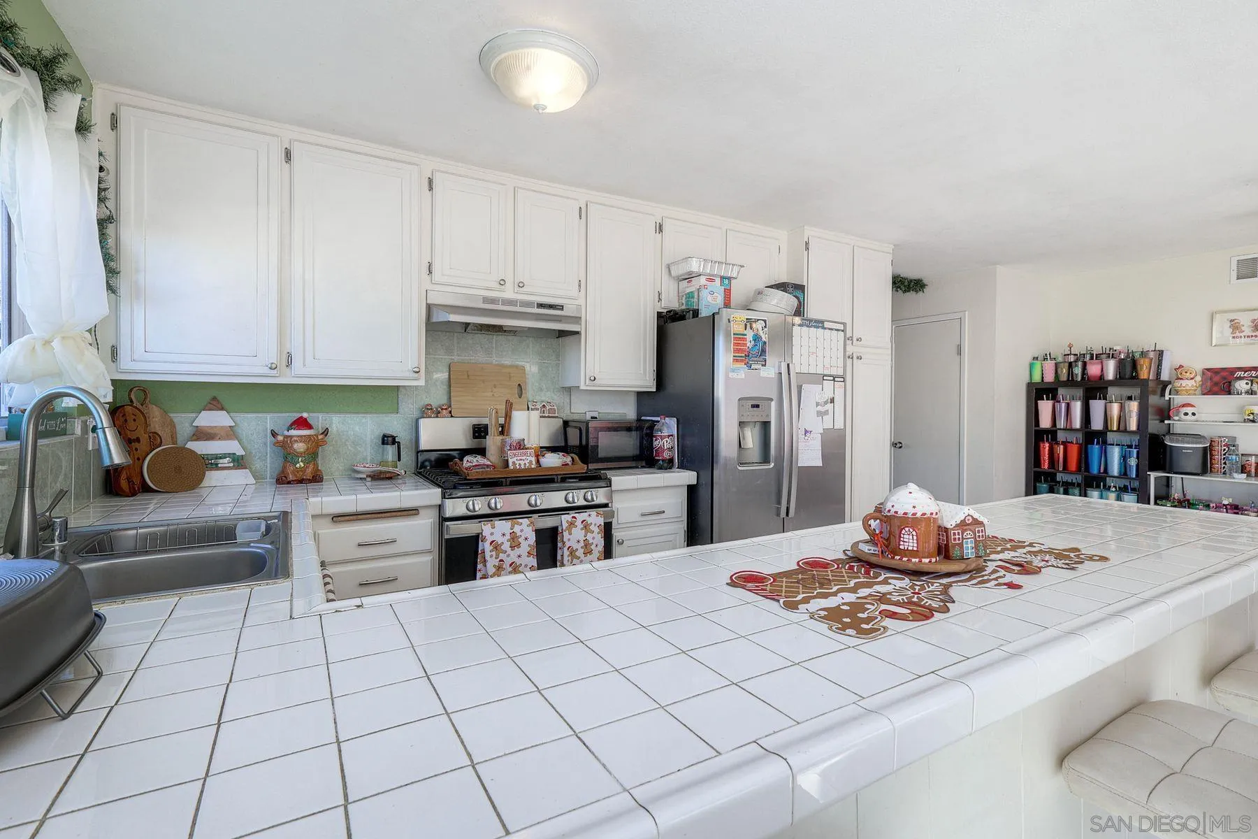 1302 Valencia Loop Chula Vista, CA 91910 - Photo 12 of 30 a kitchen with stainless steel appliances kitchen island granite countertop a sink and cabinets