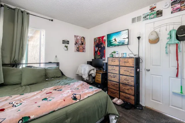 a bed sitting in a bedroom next to a window