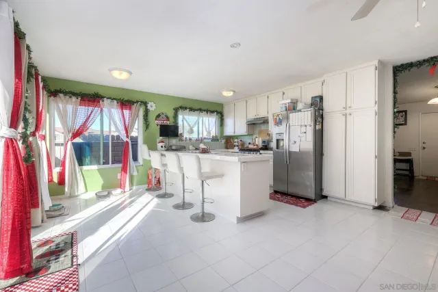 a view of a kitchen with refrigerator and a sink