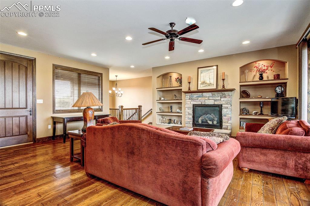 6453 Reno Road Pueblo, CO 81004 - Photo 12 of 36 a living room with furniture a fireplace and a flat screen tv