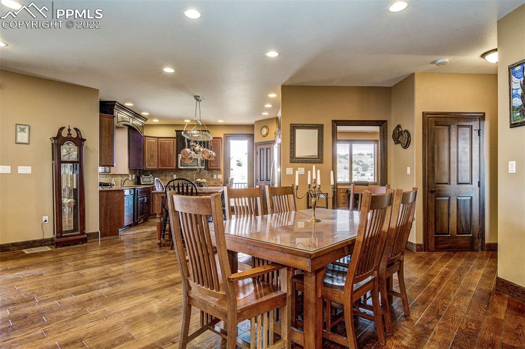 6453 Reno Road Pueblo, CO 81004 - Photo 13 of 36 a dining room with furniture and wooden floor