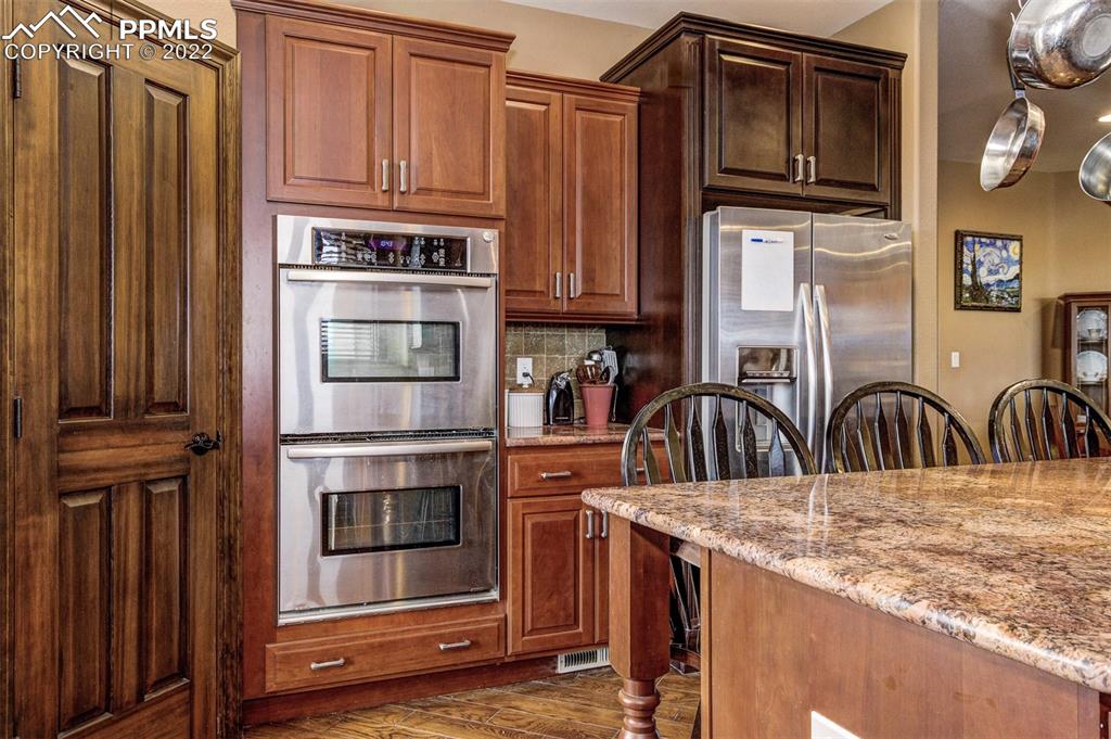 6453 Reno Road Pueblo, CO 81004 - Photo 17 of 36 a kitchen with stainless steel appliances granite countertop a refrigerator and a stove top oven