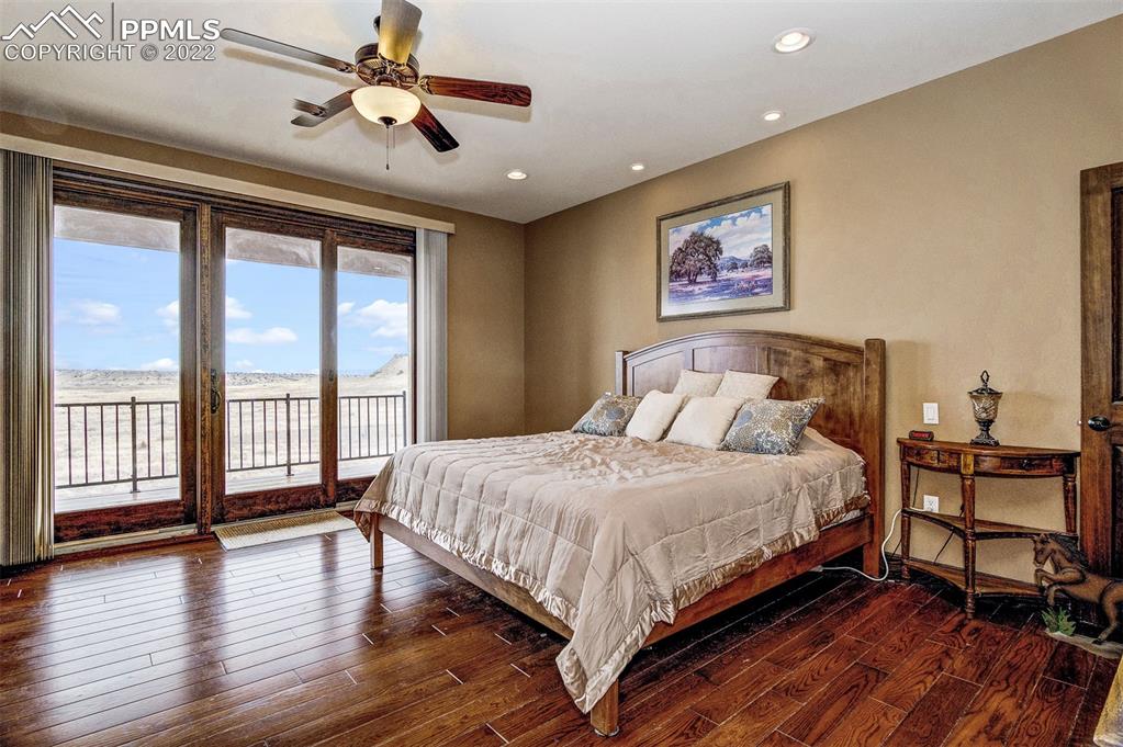 6453 Reno Road Pueblo, CO 81004 - Photo 19 of 36 a bedroom with a large bed and a large window