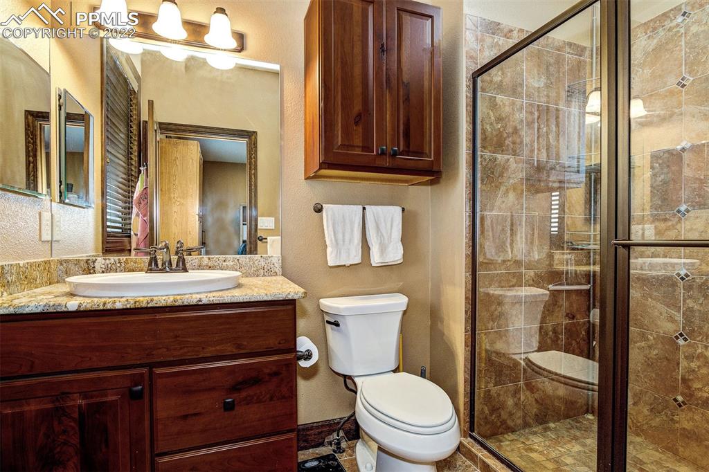 6453 Reno Road Pueblo, CO 81004 - Photo 22 of 36 a bathroom with a granite countertop sink toilet and shower