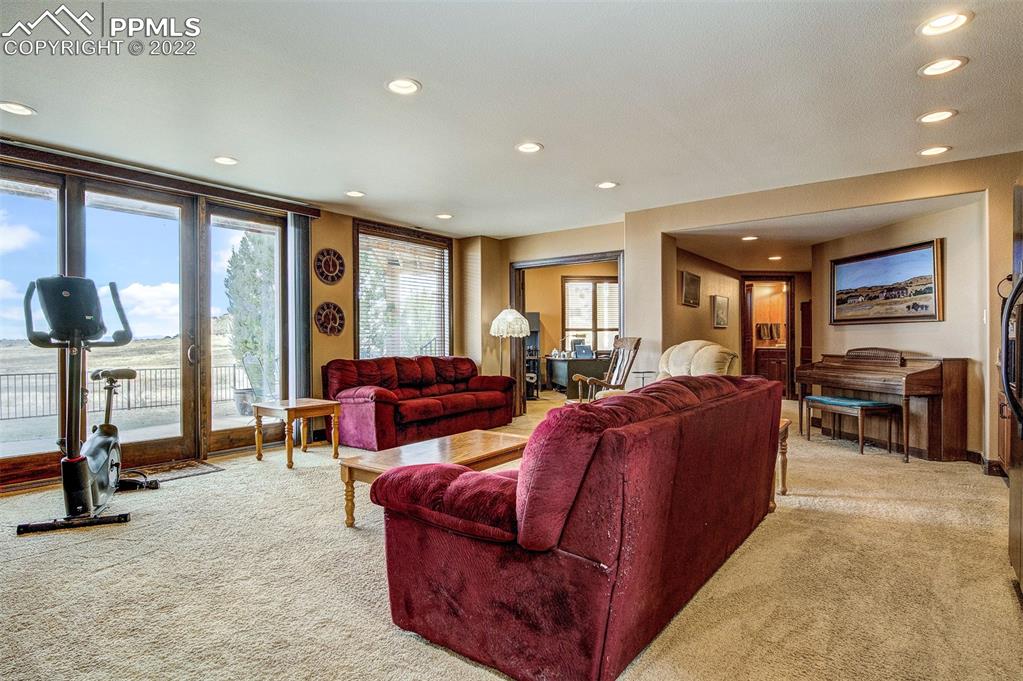 6453 Reno Road Pueblo, CO 81004 - Photo 25 of 36 a living room with furniture a large window and way to kitchen