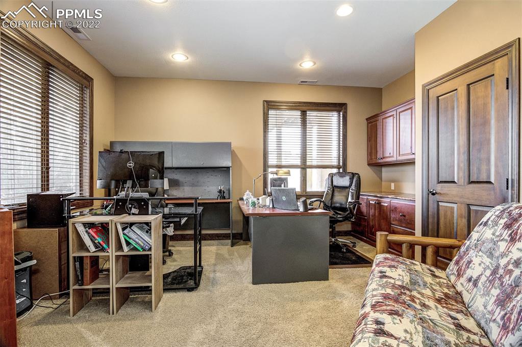 6453 Reno Road Pueblo, CO 81004 - Photo 27 of 36 a living room with furniture a flat screen tv and a window