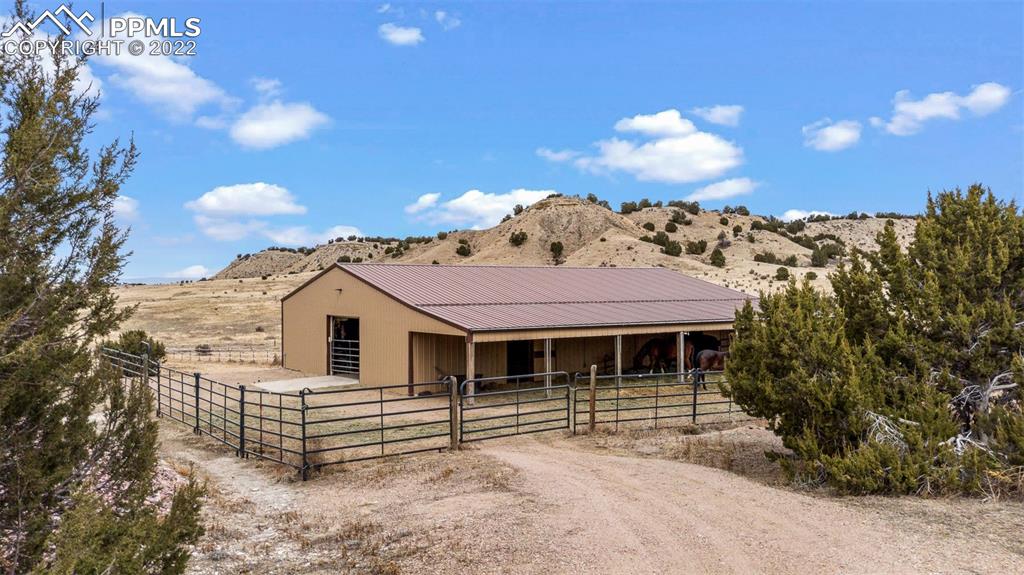 6453 Reno Road Pueblo, CO 81004 - Photo 6 of 36 a front view of a house with a yard and garage